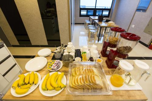 a counter with plates of bananas and oranges on them at O'guest in Haeundae in Busan