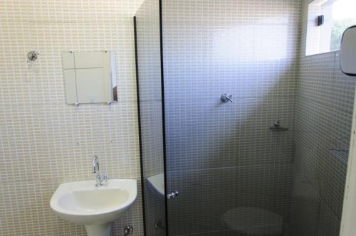 a bathroom with a sink and a shower with a toilet at Hotel Lago Conchal in Conchal