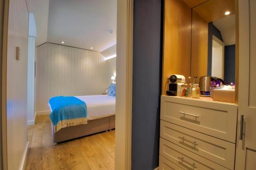 a small bedroom with a bed and a kitchen at The Orchid Hotel in Bournemouth