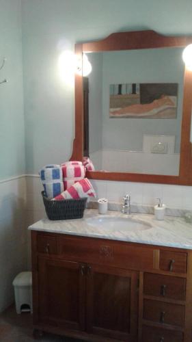 a bathroom with a sink and a mirror at Podere La Fausta in Serravalle Pistoiese