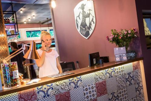 a woman standing behind a counter in a store at Pointe Isabelle in Chamonix-Mont-Blanc