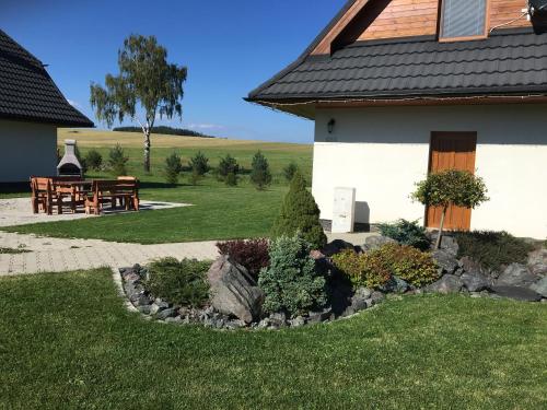 a house with a rock garden in front of it at Chalet Jayata in Stará Lesná