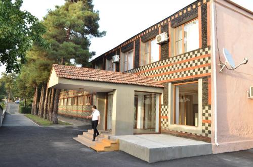 a man is standing outside of a building at Evim Otel in Zaqatala