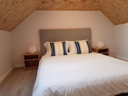 a bedroom with a white bed with two night stands at Innapartments São Gonçalinho II in Aveiro