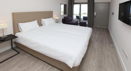 a large white bed in a hotel room at Droushia Heights Hotel in Droushia