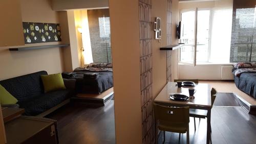 a living room with a couch and a table at Walk distance to mokotow business park in Warsaw