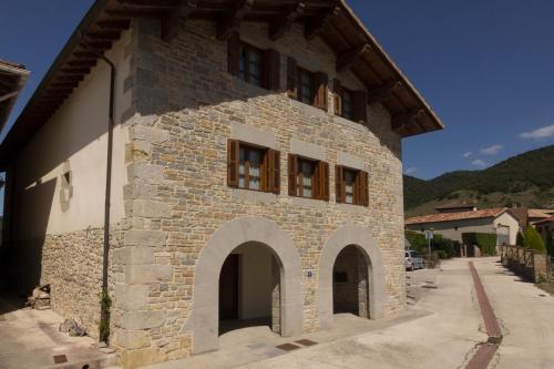 a large stone building with an archway on it at Cortea I y II in Añézcar