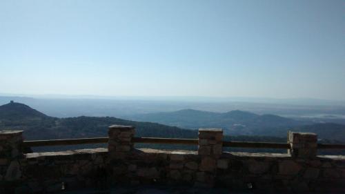 a stone wall with a view of the mountains at Apartamento Zocailla in Gata
