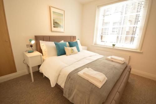 a bedroom with a large bed and a window at St Anne's Court by Indigo Flats in London