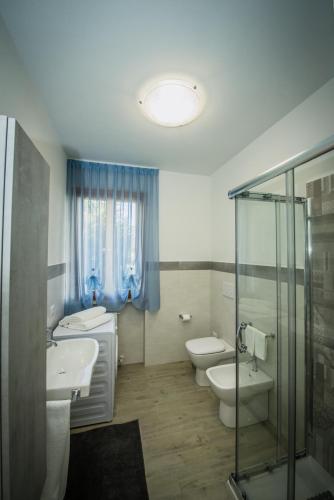 a bathroom with two toilets and a sink and a shower at Appartamenti vicino al mare in Civitanova Marche