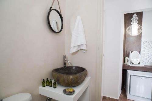 a bathroom with a bowl sink and a toilet at Villa Ilias in Firostefani