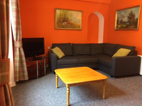 a living room with a couch and a coffee table at Central Dumfries in Dumfries