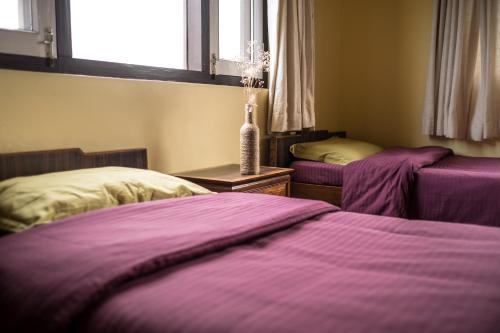 A bed or beds in a room at Swayambhu View Guest House