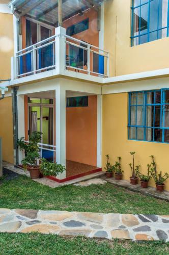 a house with plants in front of it at Merlin Guest House in Rodrigues Island