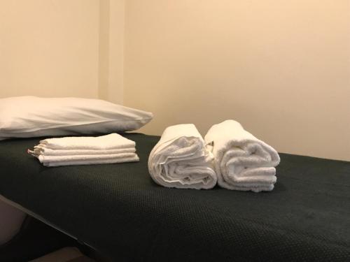 a bed with towels and towels on top of it at Royal in Sestriere