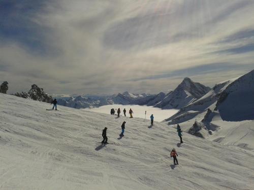 a group of people skiing down a snow covered slope at Haus Waldheim in Tux