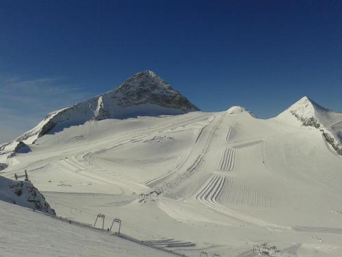 a mountain covered in snow with a ski slope at Haus Waldheim in Tux