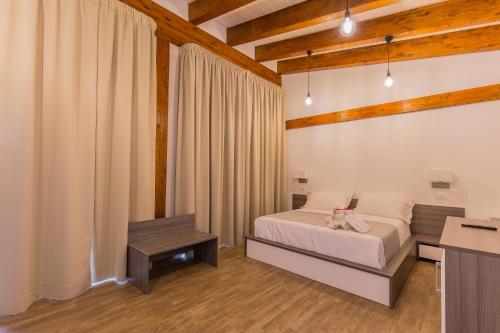 a bedroom with a bed and a table in a room at Il Semaforo Sila Hotel in Taverna