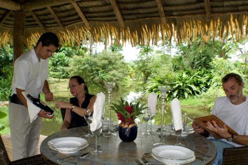 a group of people sitting around a table at Hacienda La Isla Lodge in Sarapiquí