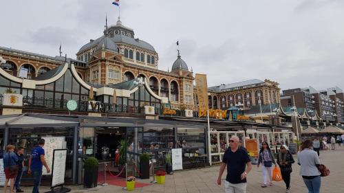 a group of people walking in front of a building at SmallStay on the Beach in Scheveningen