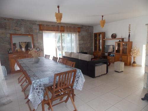 a living room with a table and a couch at Casa Silva Do Minho in Arcos de Valdevez