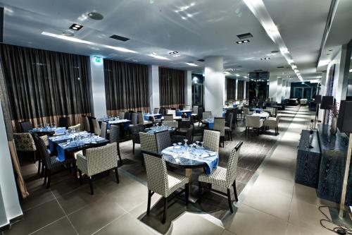 a dining room with blue tables and chairs at Olympus Thea Boutique Hotel in Platamonas