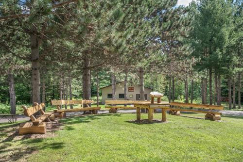 a group of picnic tables and benches in a park at Super 8 by Wyndham Phillips in Phillips