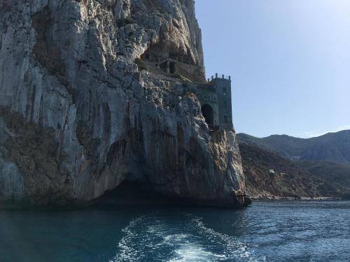 a building on a cliff next to the water at Villa Laura in Nebida