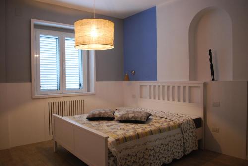 a bedroom with a bed with two pillows on it at Casa Polly B&B in Grottammare