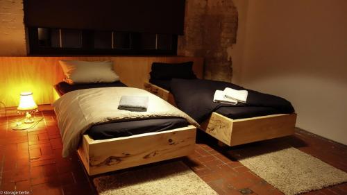 a bedroom with a twin bed and a night stand at Storage Loft Apartment in Berlin