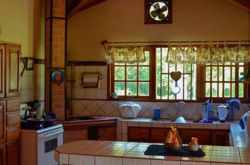 a kitchen with a table and a clock on the wall at Casa Cora Bed and Breakfast in Colonia Carmona