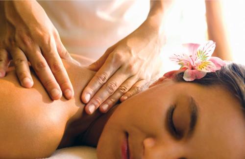 a woman getting a massage from a therapist at Court Road House in Cardiff