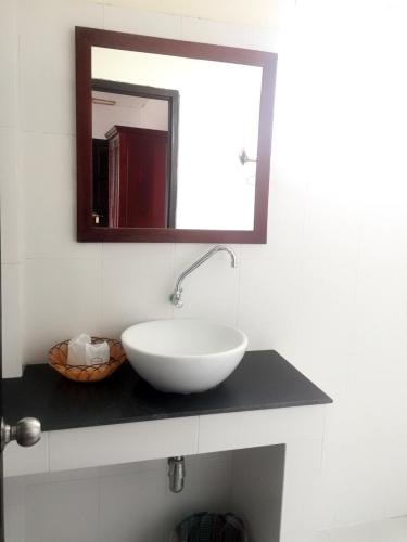 a bathroom with a white sink and a mirror at Vientiane SP Hotel in Vientiane