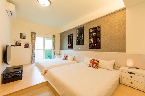 a bedroom with two beds and a tv at Sky Bird Garden B&B in Wujie