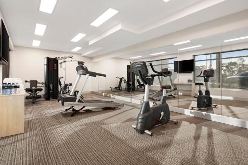 a gym with treadmills and exercise bikes in a room at Quest Eight Mile Plains in Brisbane