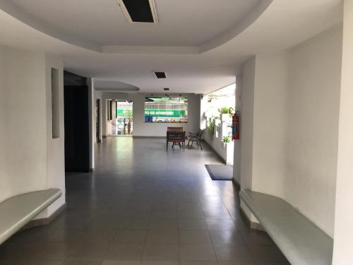 an empty hallway with benches in a building at Loft Paris in Niterói