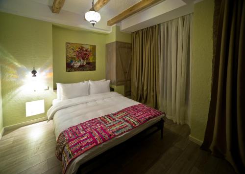 a bedroom with a large bed and a window at No12 Boutique Hotel in Tbilisi City