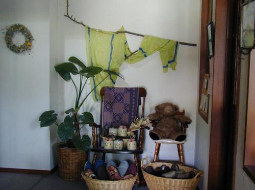 a room with a chair and a stuffed bear and a plant at Pension Rapport in Tambara Plateau in Numata