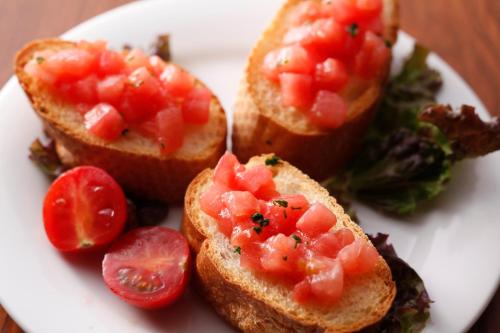 a white plate with sandwiches with tomatoes on it at Kinosaki Yamamotoya in Toyooka