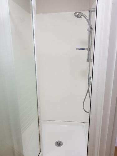 a shower with a glass door in a bathroom at Aero Auckland Airport in Auckland