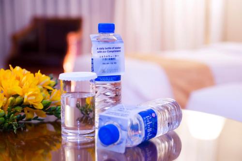 a bottle of water sitting on top of a table at Sejong Hotel Seoul Myeongdong in Seoul