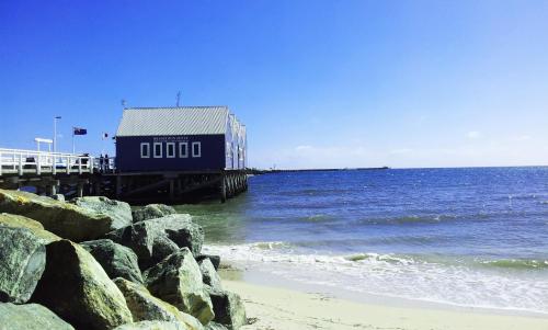 a building on a pier next to the ocean at Carpe Diem South in Busselton