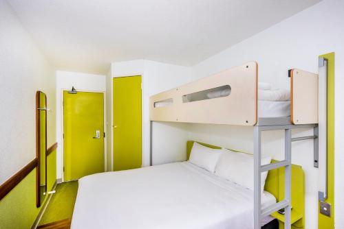 a small room with a bunk bed and a ladder at ibis Budget - St Peters in Sydney