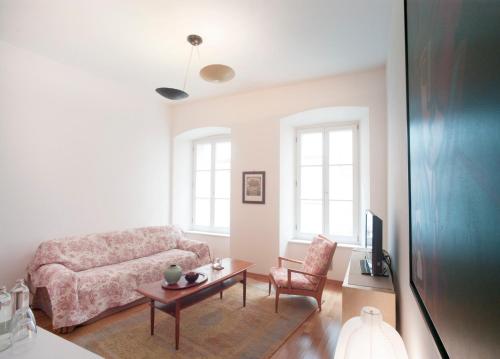 a living room with a couch and a table at Boutique Hotel Albero Nascosto in Trieste
