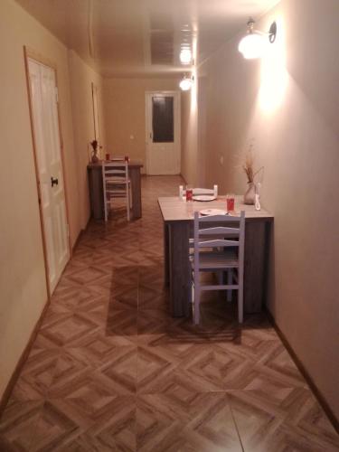 a room with a table and chairs in a room at Lakeside Green Balcony Home in Tskaltubo