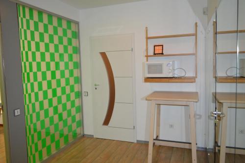 a small kitchen with a green and white wall at Vasarely Luxury Flat in Satu Mare
