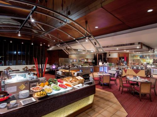 a restaurant with a buffet line with food on display at Shangri-La Chiang Mai in Chiang Mai