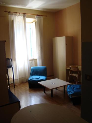 sala de estar con mesa y silla azul en Giappone Inn Flat en Livorno
