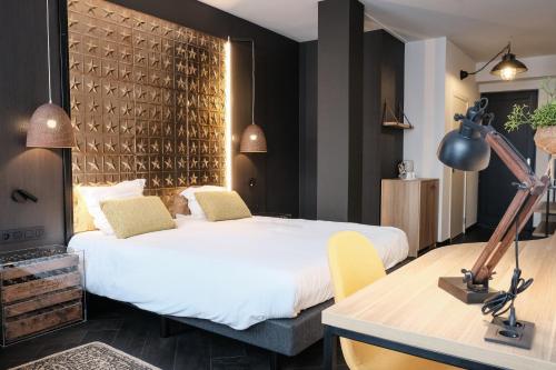En eller flere senge i et værelse på Hotel Brouwerij Het Anker
