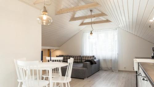 a living room with a table and chairs and a couch at Best Stay- Pärnu With Garden in Pärnu